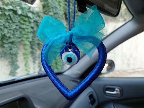 An Evil Eye Hanging From The Dashboard Of A Car