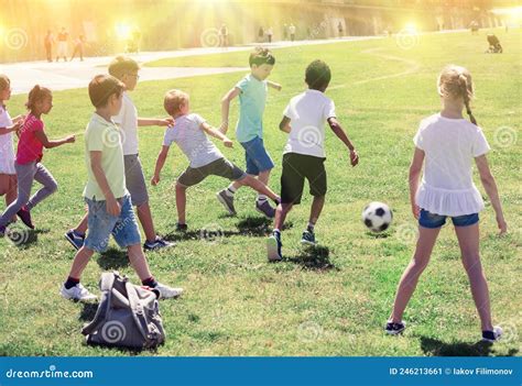 Group Of Kids Are Running And Playing Football In The Park Stock Image