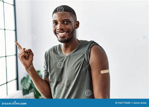 Young African American Man Getting Vaccine Showing Arm With Band Aid