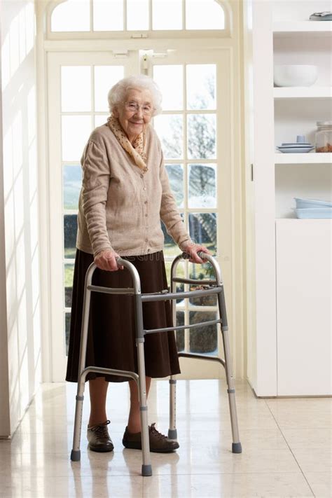 Elderly Senior Woman Using Walking Frame Stock Photo - Image of seniors, caucasian: 18869164