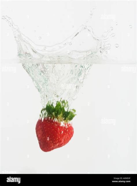 Strawberry Dropped Into Water Stock Photo Alamy