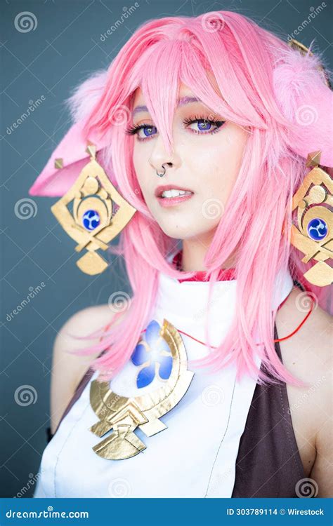 Female Cosplayer in a Pink Anime Costume Wearing Pink Hair Stock Photo ...