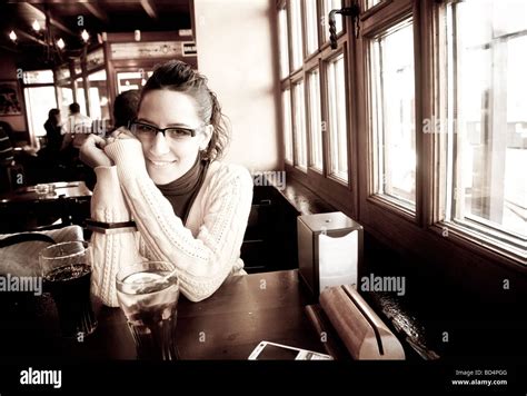 Young cheerful woman drinking in a pub Stock Photo - Alamy