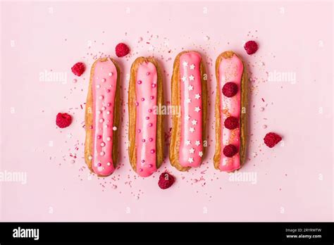 Creative Layout Made Of Eclairs With Pink Glaze On Pink Background