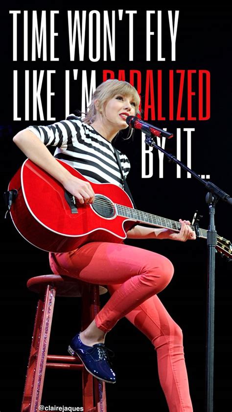 A Woman Sitting On Top Of A Stool While Holding A Guitar In Front Of A