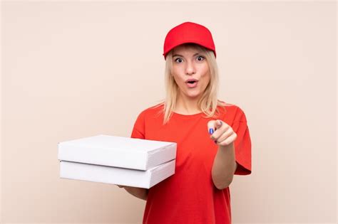 Premium Photo Pizza Delivery Russian Woman Holding A Pizza Over Isolated Wall Surprised And