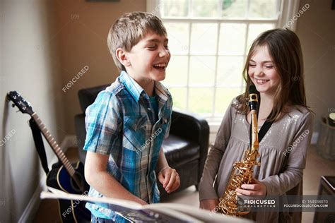 Children playing with saxophone — brunette, guitar - Stock Photo ...