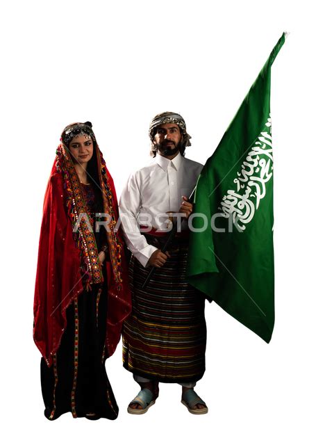 Portrait of a Saudi Arabian Gulf woman and man wearing the traditional Saudi dress for national ...