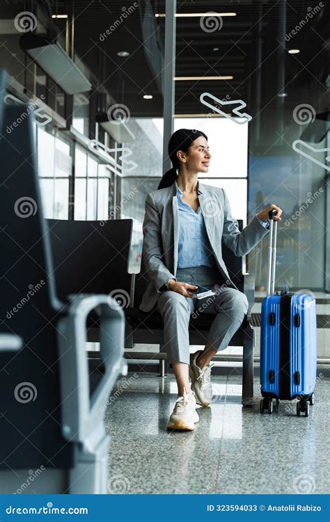 Business Woman Sitting In Airport And Waiting For Starting Her Travel