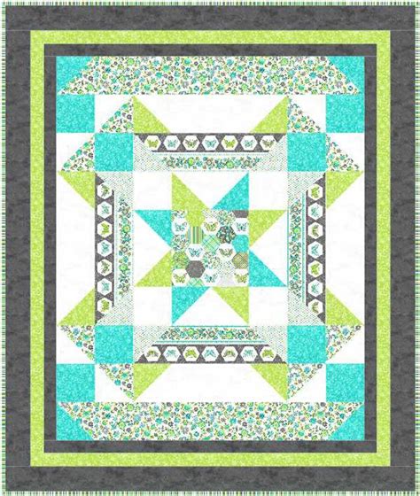 A Green And Blue Quilt With A Star On It