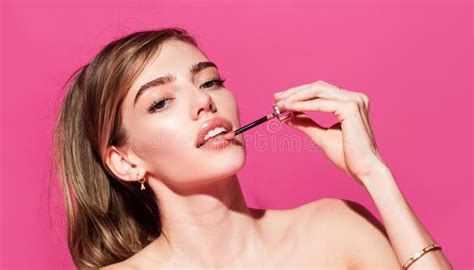 Young Woman Applies Pink Lipstick On Lips Beautiful Woman Face With