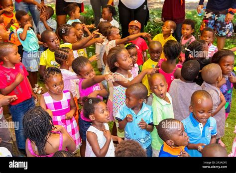 Young African Preschool kids singing songs in the playground of a ...