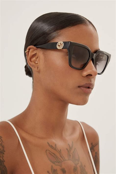 Gucci Cat Eye Black Sunglasses With Integrated Gg Logo In Brown Lyst Uk