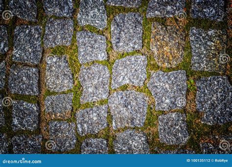 Abstract Background Of Old Cobblestone Pavement Texture With Nat Stock