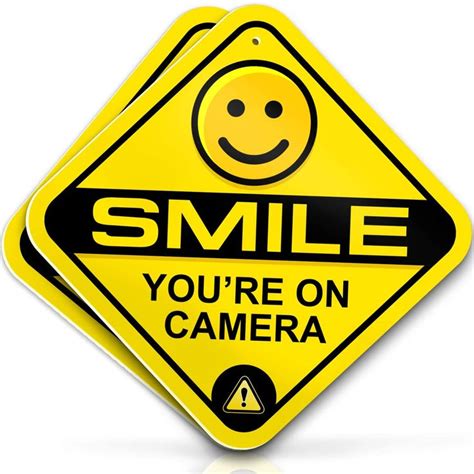 A Yellow Smile You Re On Camera Sign