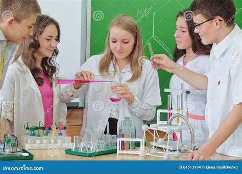 Alumnos Que Hacen El Experimento En Clase De La Ciencia Foto De Archivo