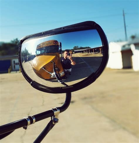 Premium Photo | Man taking selfie in side-view mirror reflection of ...