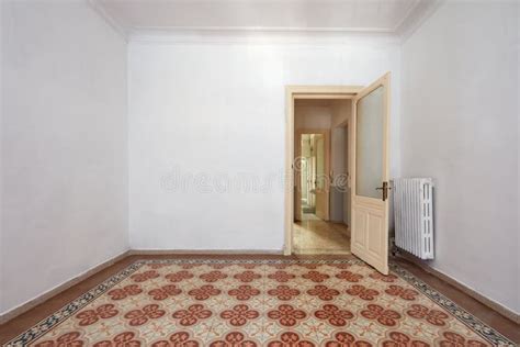 Empty Room Interior With Ancient Tiled Floor And Wooden Door Stock