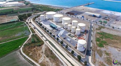 An Aerial View Of Oil Storage Tanks In The Middle Of A Rural Area Near