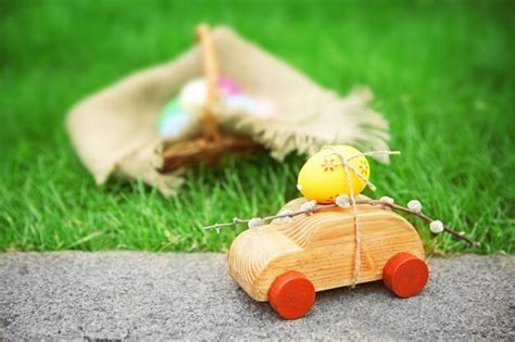 Premium Photo Decorative Toy Car With Pussy Willow And Easter Egg On Green Grass Background