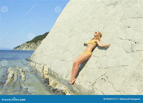 Blonde Posing Leaning Against Rock Near Ocean Coast Stock Photo Image