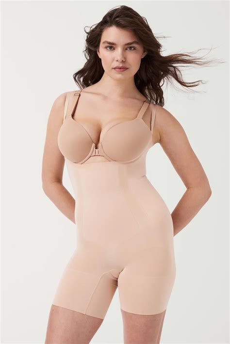 The Oncore Open Bust Mid Thigh Bodysuit By Spanx In Soft Nude Ginia