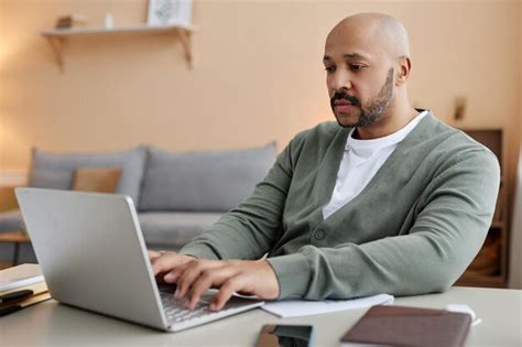 Premium Photo Adult Black Man Using Laptop Working From Home In Setting