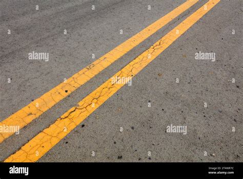 Yellow double solid line Stock Photo - Alamy