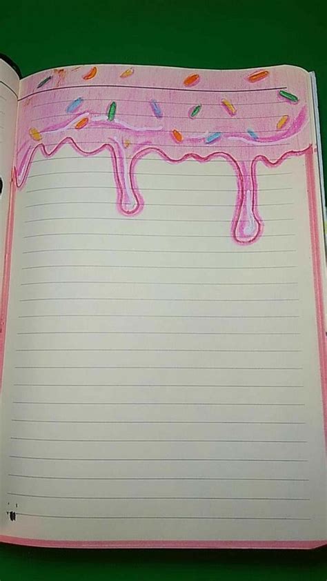 An Open Notebook With Pink Frosting And Sprinkles On The Inside