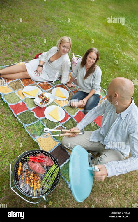 Friends Eating Food At An Outdoor Picnic Stock Photo Alamy