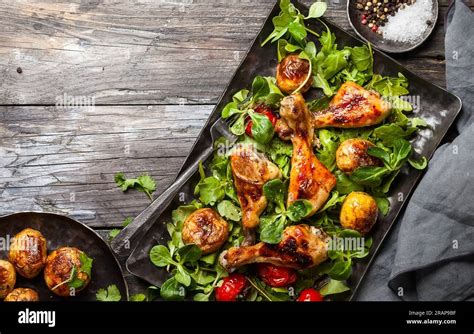 Spicy Roasted Chicken Legs With Potatoes And Salad Top View Food In