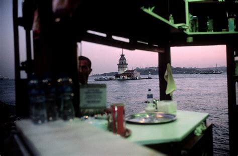 Alex Webb, TURKEY. Istanbul. 2004. South of Uskudar, cafe with Maiden tower (and distant mosques ...