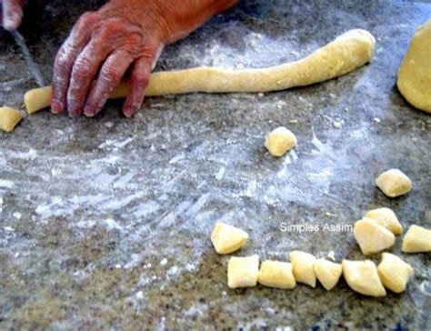 A Person Is Kneading Dough On Top Of A Table With Other Food Items