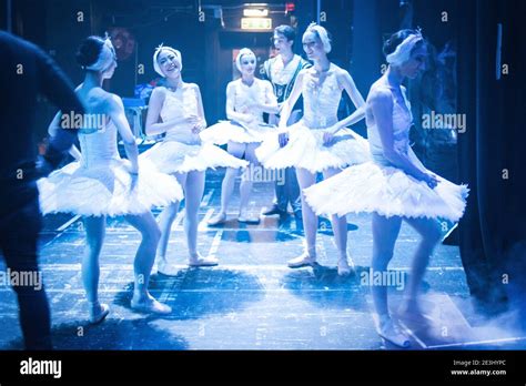 Five Ballet Dancers Backstage Sharing A Joke In White Tutus Before