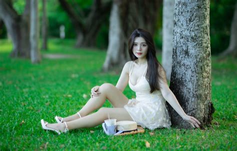 4K Asian Grass Bokeh Brunette Girl Sitting Dress Hands