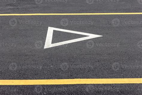 Give way sign on asphalt road 11088330 Stock Photo at Vecteezy