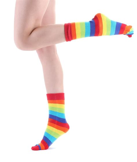 Premium Photo | Female legs in colorful striped socks isolated on white