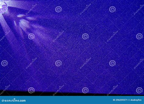 On A Blue Gradient Background Scattered Light Purple Rays Of Light