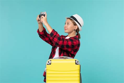 Free Photo Front View Young Female Going In Trip And Holding Camera