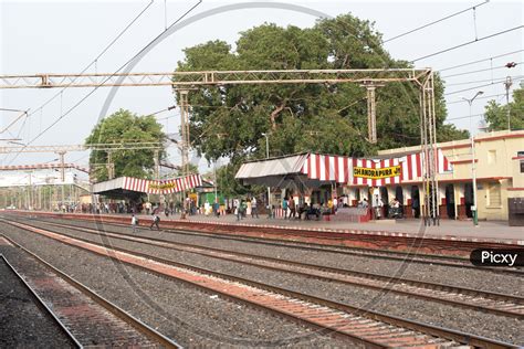 Image of A Railway Station With Passengers Waiting For The Train With a ...