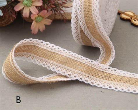 A Close Up Of A Ribbon On A Table With Flowers In The Backgrouf