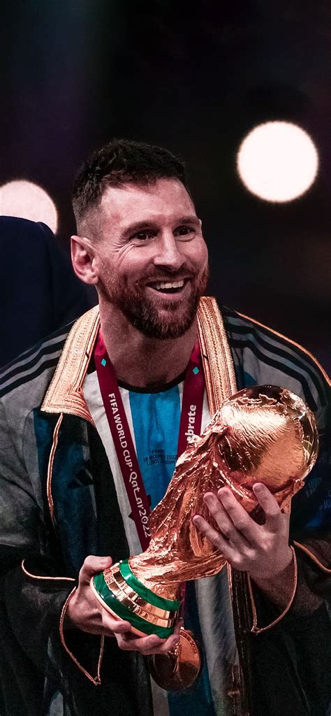 a man holding a golden soccer ball in his hands