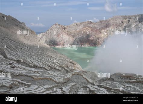 Turquoise Green Coloured Acidic Volcanic Crater Lake With Steam Rising