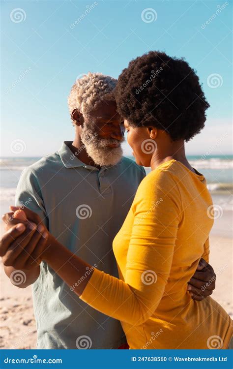 Romantic African American Couple Dancing At Beach Against Sea And Clear