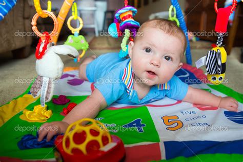 Happy And Curious Infant Baby Boy Playing On Activity Mat ⬇ Stock Photo