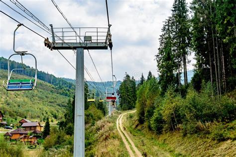 Cableway in the Mountains. the Girl is Carrying a Bicycle on Top of the ...