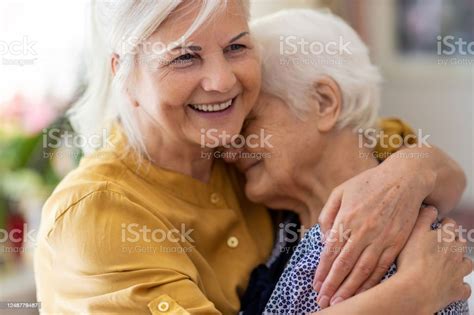 Woman Spending Time With Her Elderly Mother Stock Photo Download