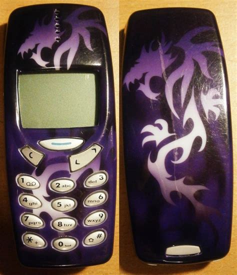 two cell phones with designs on them sitting next to each other, one is purple and the other is ...