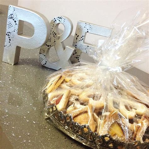 A Plastic Bag Filled With Cookies Next To The Letters P And F On A Table