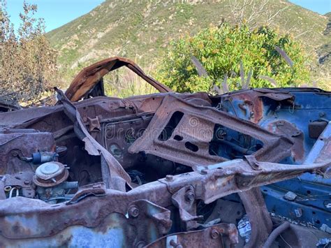 Rustic Abandoned Car In The Mountain Against Blue Sky Stock Image